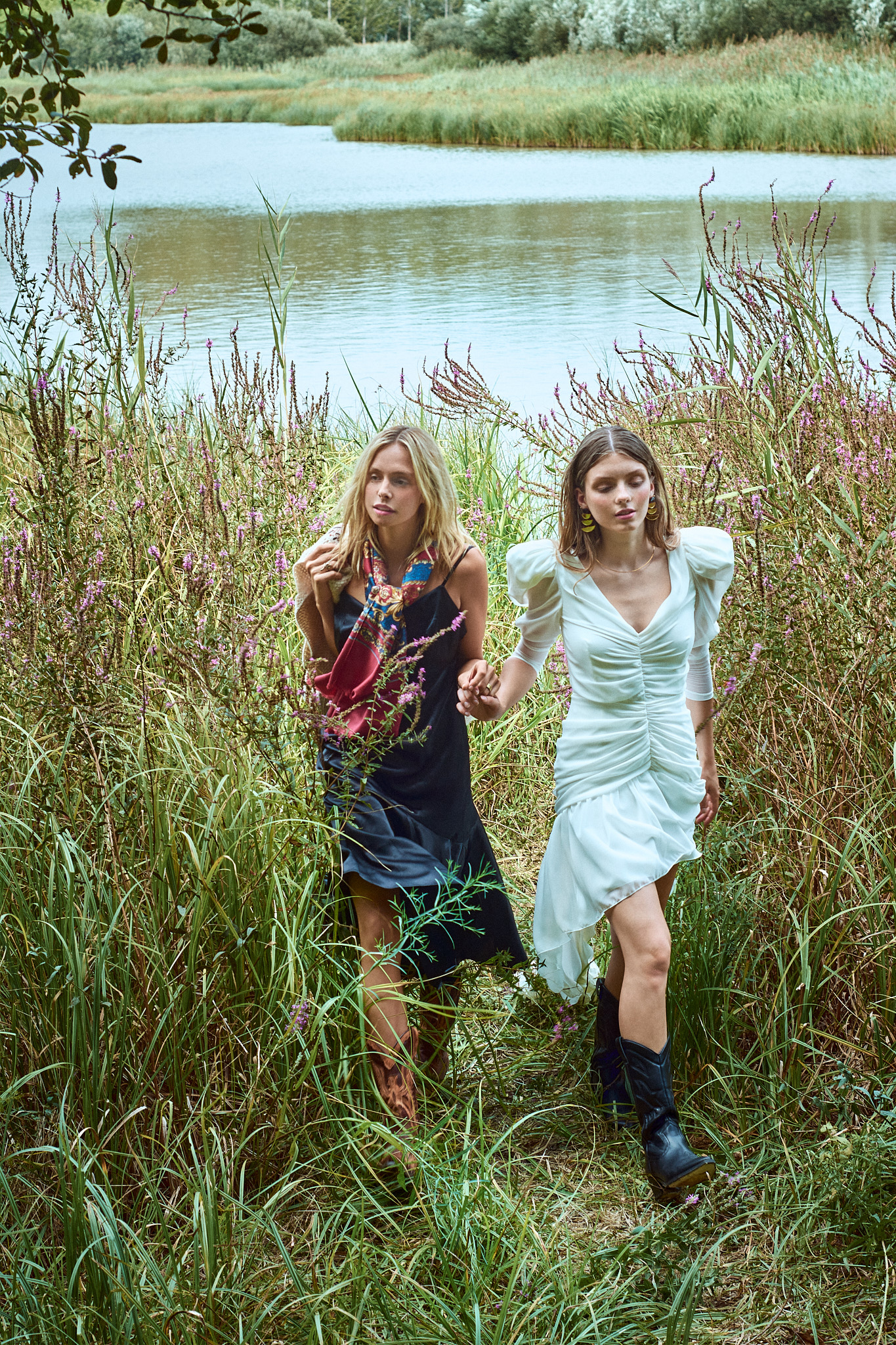 fashion editorial two models walking through countryside landscape
